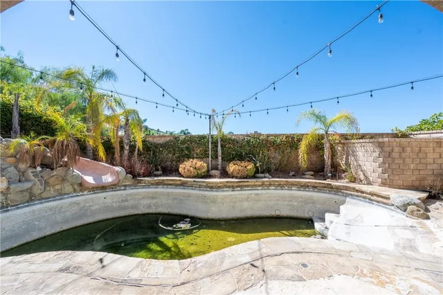 a view of a swimming pool with a yard