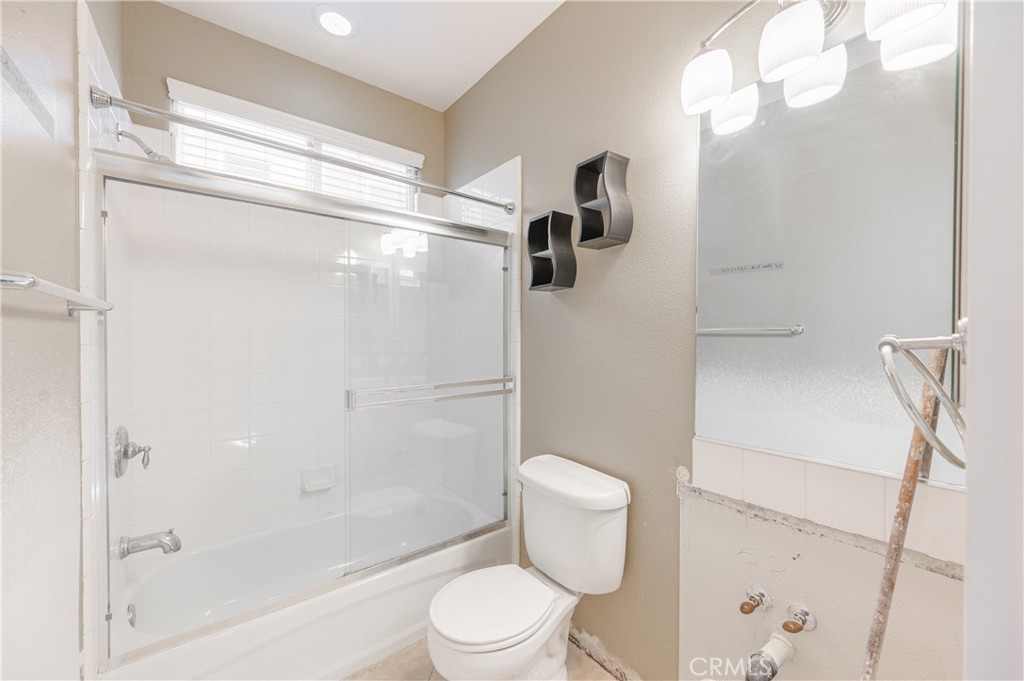 29276 Discovery Ridge Drive Saugus, CA 91390 - Photo 7 of 21 a white toilet sitting next to a bath tub shower