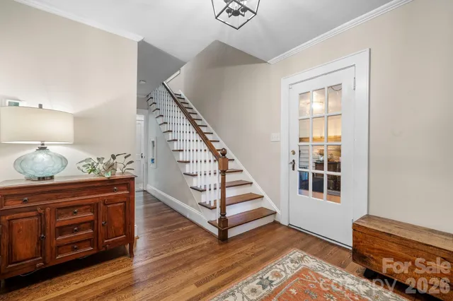 a view of entryway with wooden floor and cabinet
