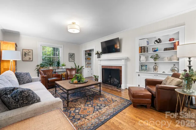 a living room with furniture flat screen tv and a fireplace