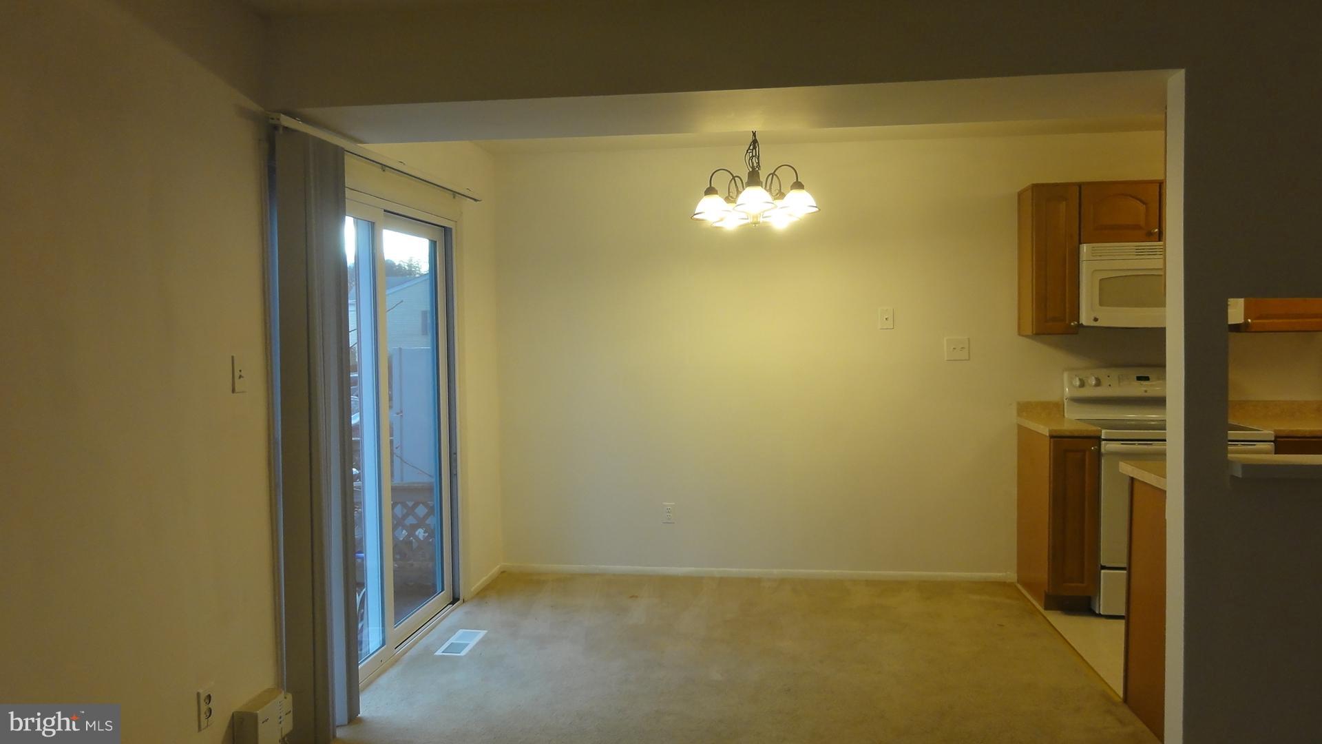 11 Benwell Road, Unit C Reisterstown, MD 21136 - Photo 4 of 16 Dining Room w/Carpet & Chandlier