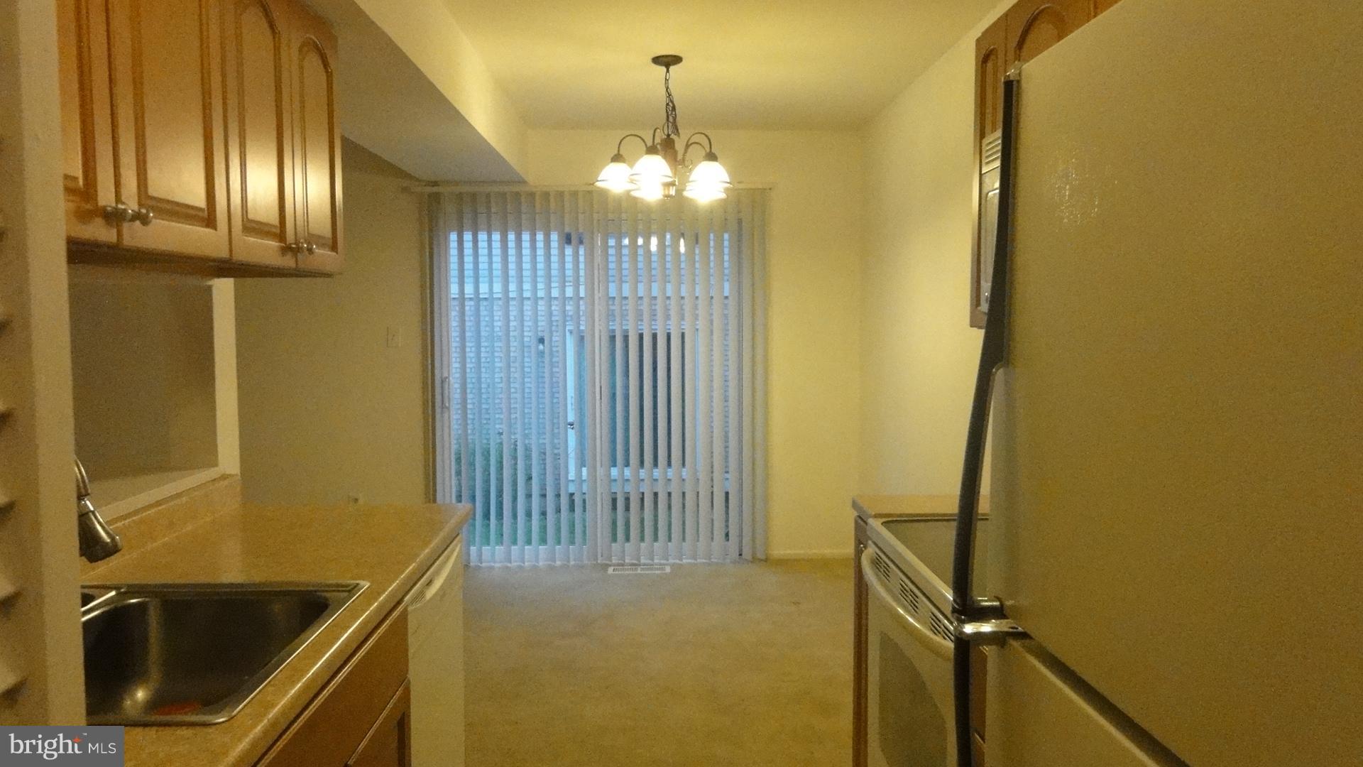 11 Benwell Road, Unit C Reisterstown, MD 21136 - Photo 8 of 16 Kitchen Flows to Dining Room w/Sliders