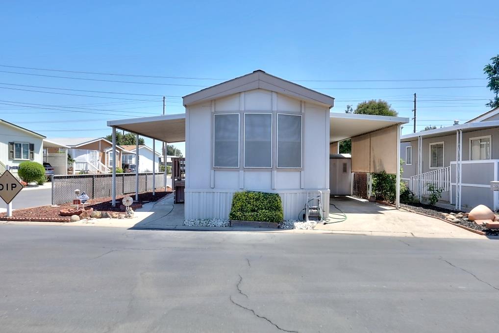 3506 Homestead Way Ceres, CA 95307 - Photo 1 of 39 a view of a brick house with a small yard and plants