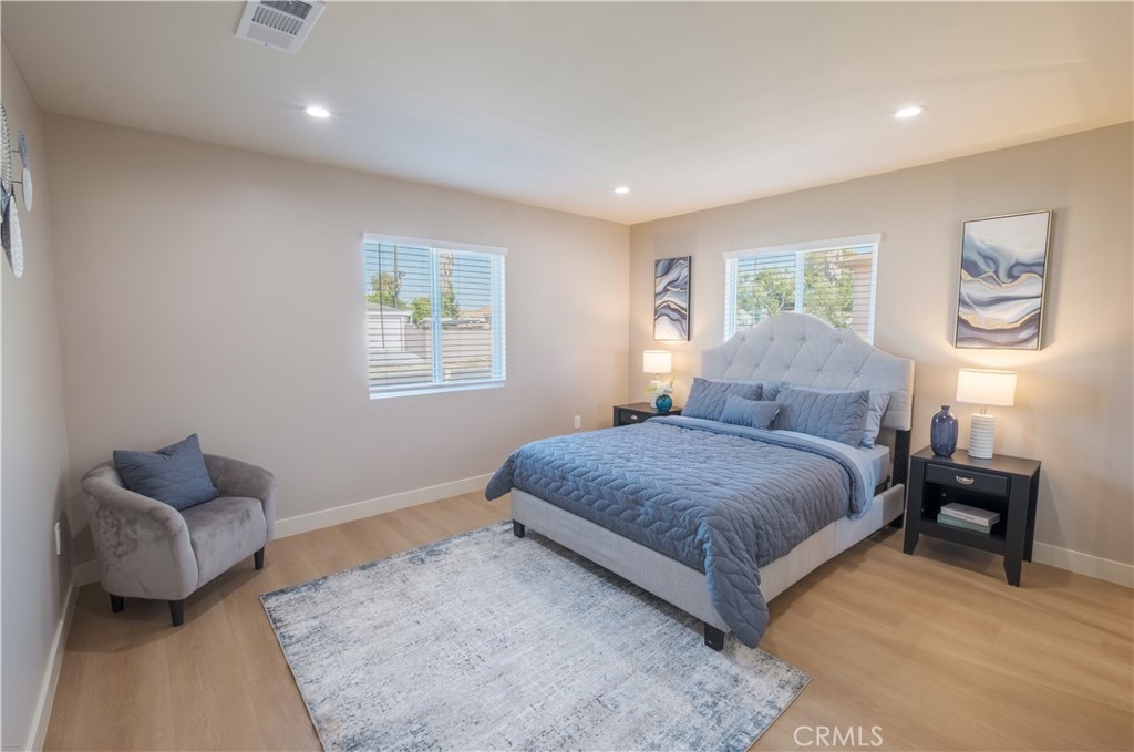 223 South Aprilia Avenue Compton, CA 90220 - Photo 10 of 46 a bedroom with a bed and wooden floor