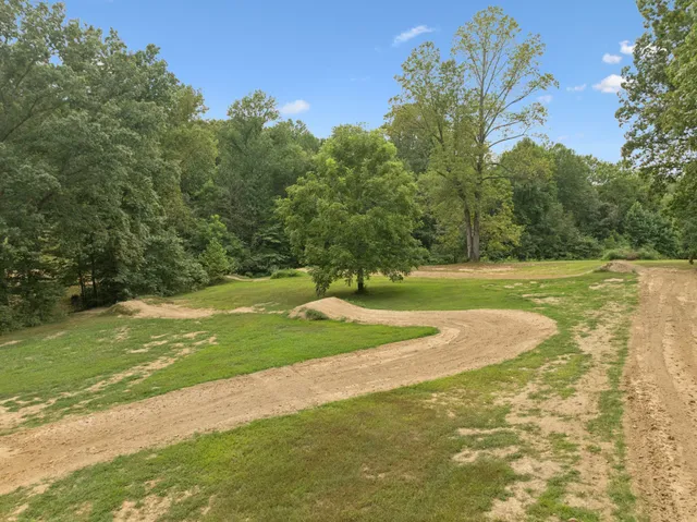 a view of a field with trees around
