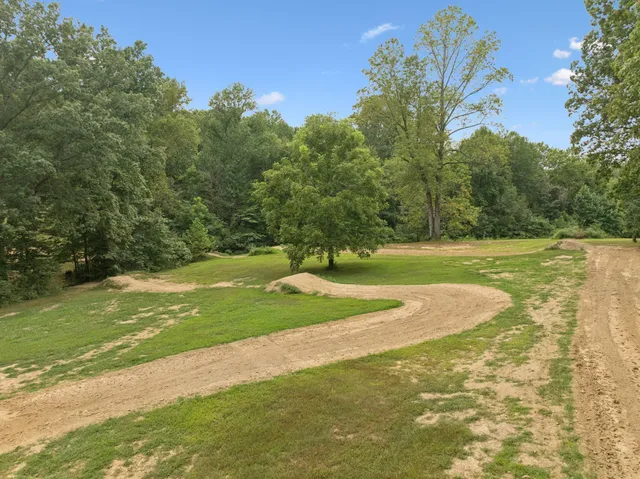 a view of a field with trees around