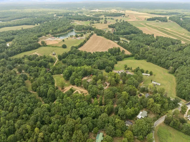 an aerial view of ocean and residential houses with outdoor space