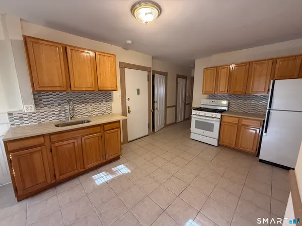 a kitchen with stainless steel appliances granite countertop a refrigerator sink and cabinets
