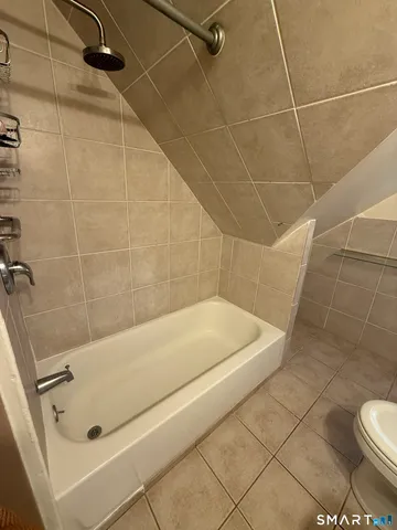 a bathroom with a white bath tub and a shower