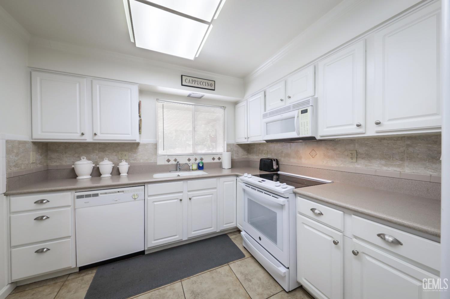 Undisclosed Address Bakersfield, CA 93309 - Photo 11 of 22 a kitchen with cabinets appliances a sink and a window