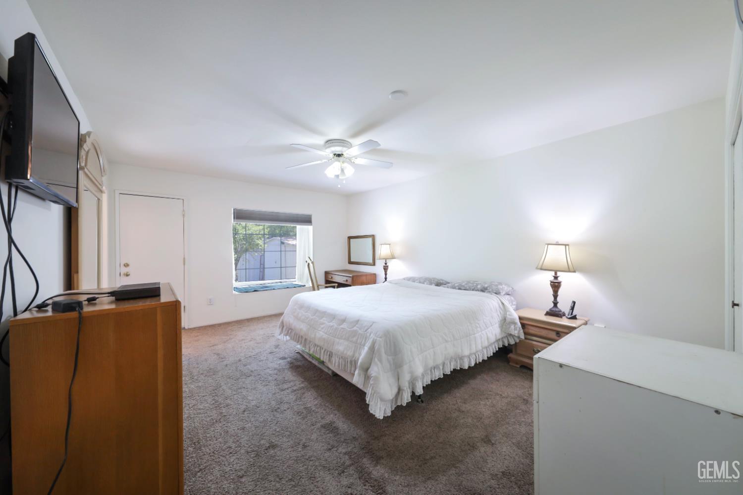 Undisclosed Address Bakersfield, CA 93309 - Photo 13 of 22 a bedroom with a bed and a chandelier
