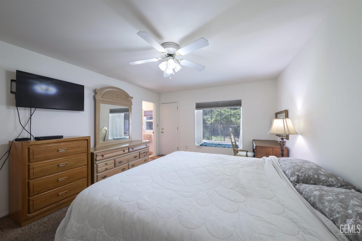 Undisclosed Address Bakersfield, CA 93309 - Photo 14 of 22 a bedroom with a bed and a chandelier