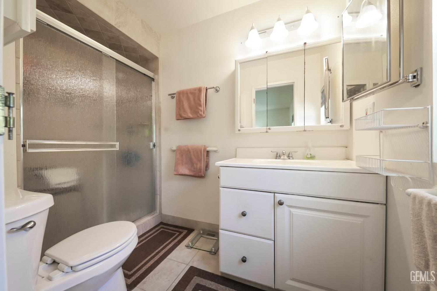 Undisclosed Address Bakersfield, CA 93309 - Photo 15 of 22 a bathroom with a sink toilet and shower