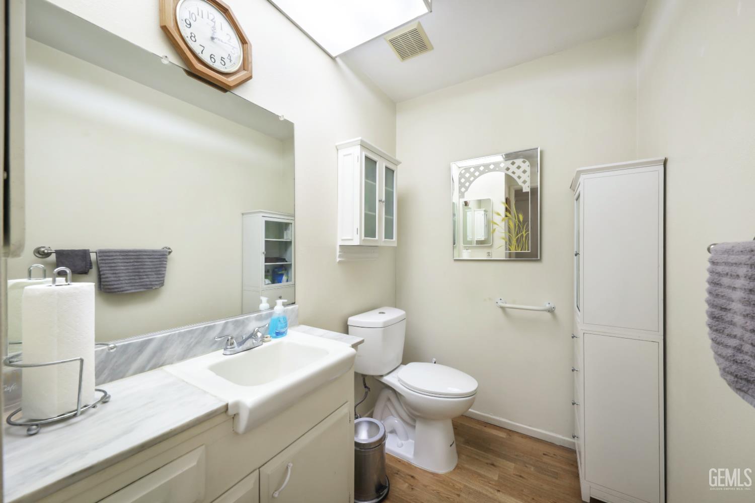Undisclosed Address Bakersfield, CA 93309 - Photo 16 of 22 a bathroom with a sink a toilet and a mirror