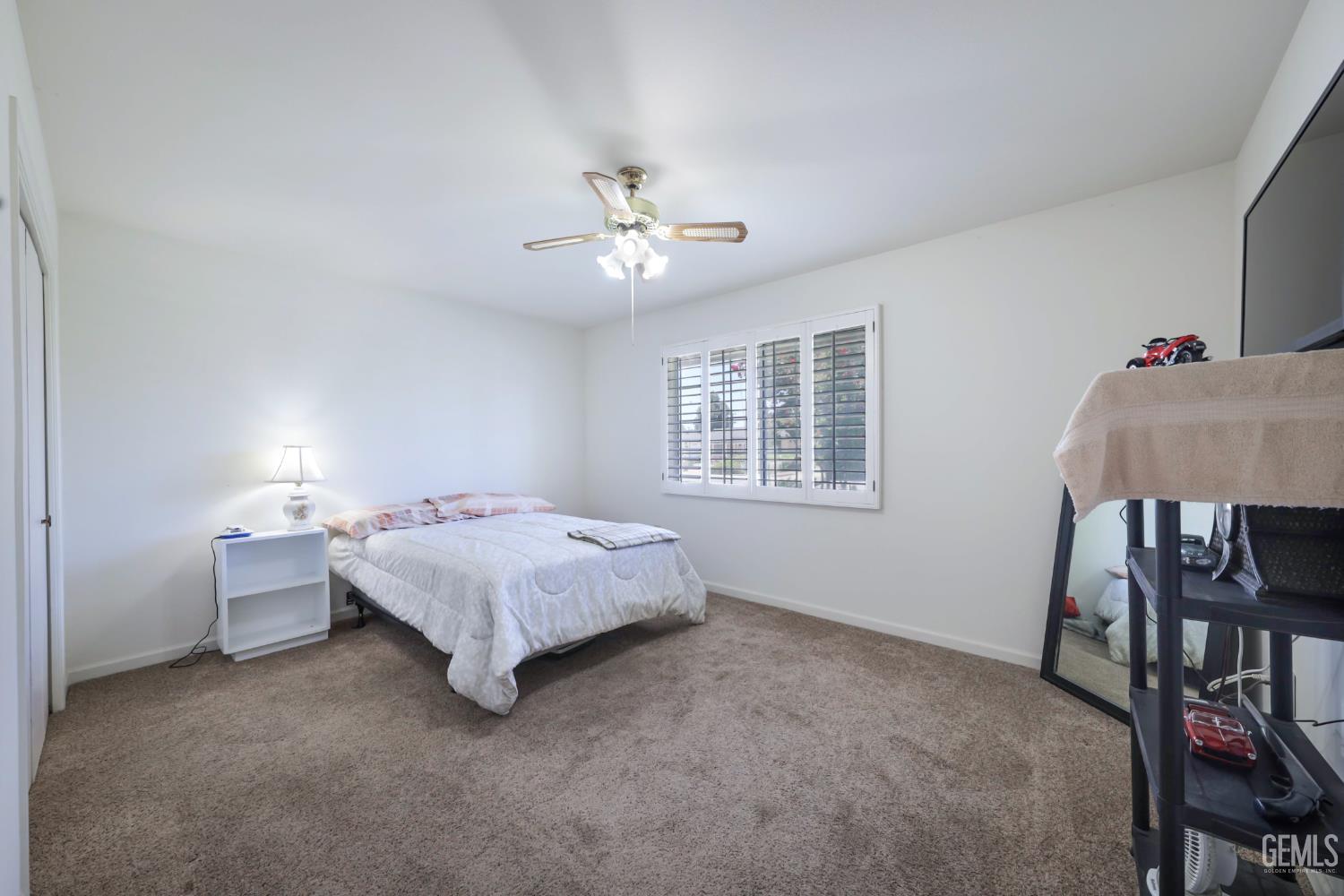 Undisclosed Address Bakersfield, CA 93309 - Photo 17 of 22 a bed room with a bed and a chair