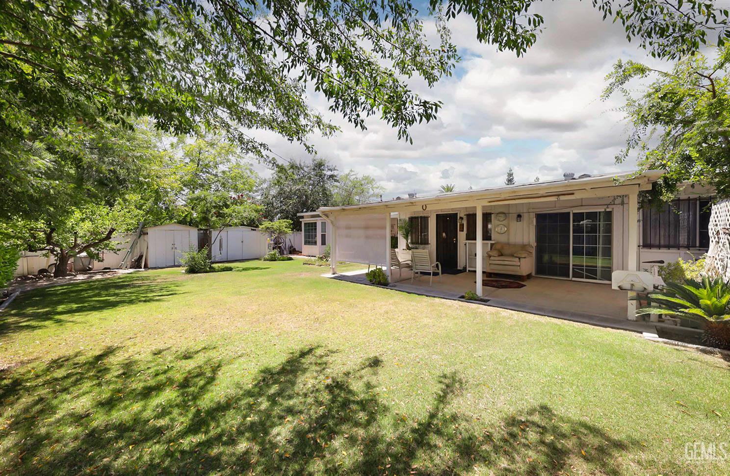 Undisclosed Address Bakersfield, CA 93309 - Photo 20 of 22 a front view of house with yard and trees in the background