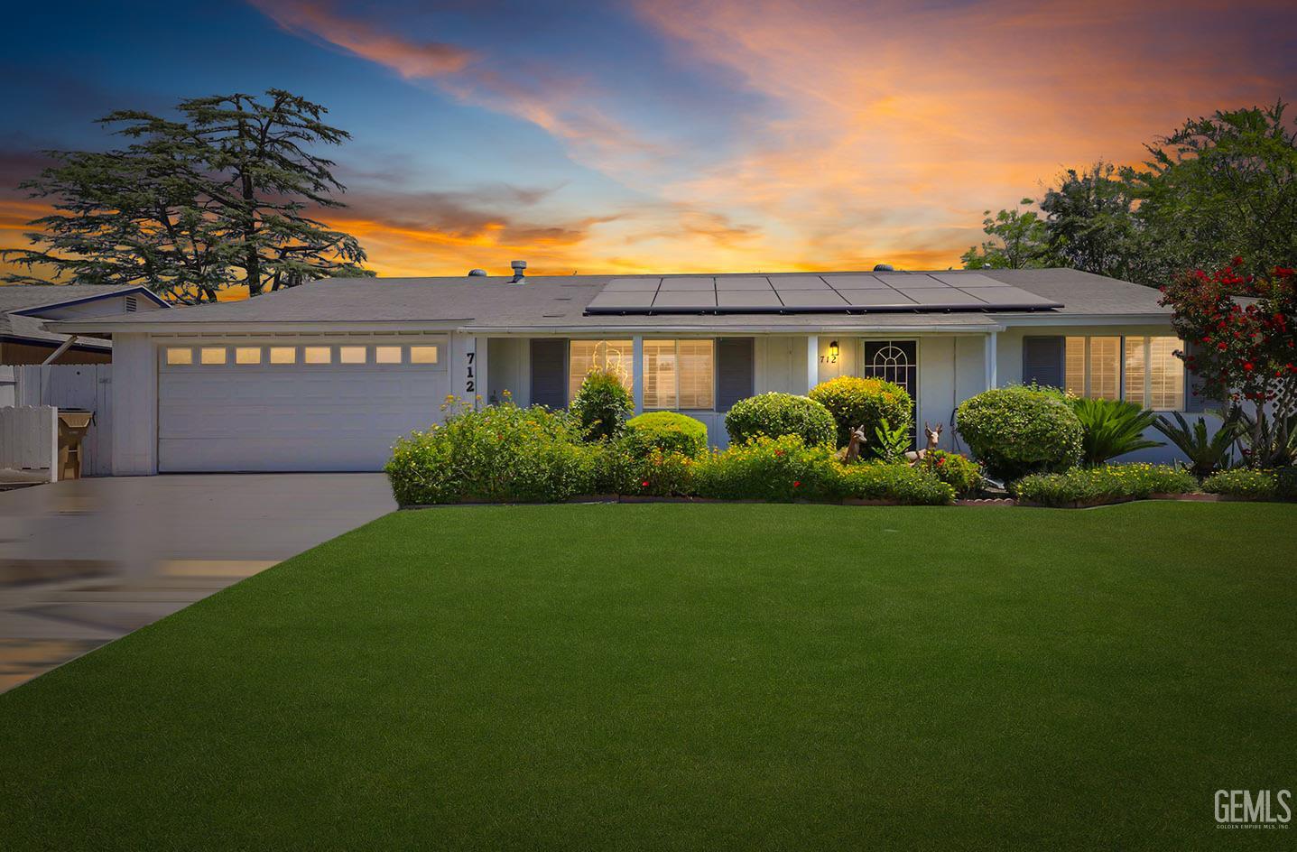 Undisclosed Address Bakersfield, CA 93309 - Photo 2 of 22 a front view of a house with a garden