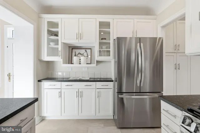 a kitchen with stainless steel appliances granite countertop a refrigerator and a stove