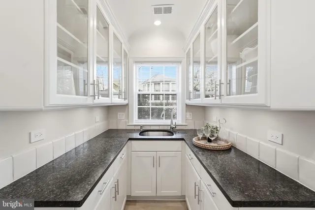 a kitchen with stainless steel appliances granite countertop a sink stove and cabinets