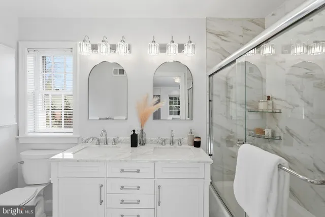 a bathroom with double vanity sink and a mirror