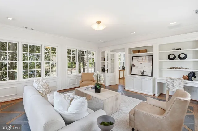 a living room with furniture and floor to ceiling window