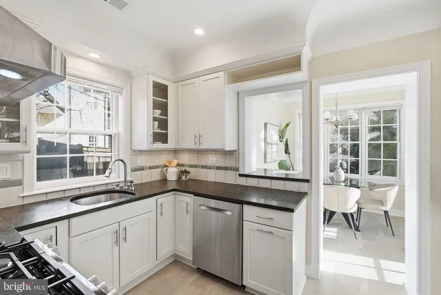 a kitchen with a sink stove and cabinets