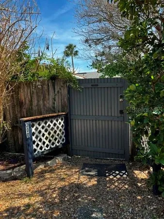 a wooden fence with trees in the background