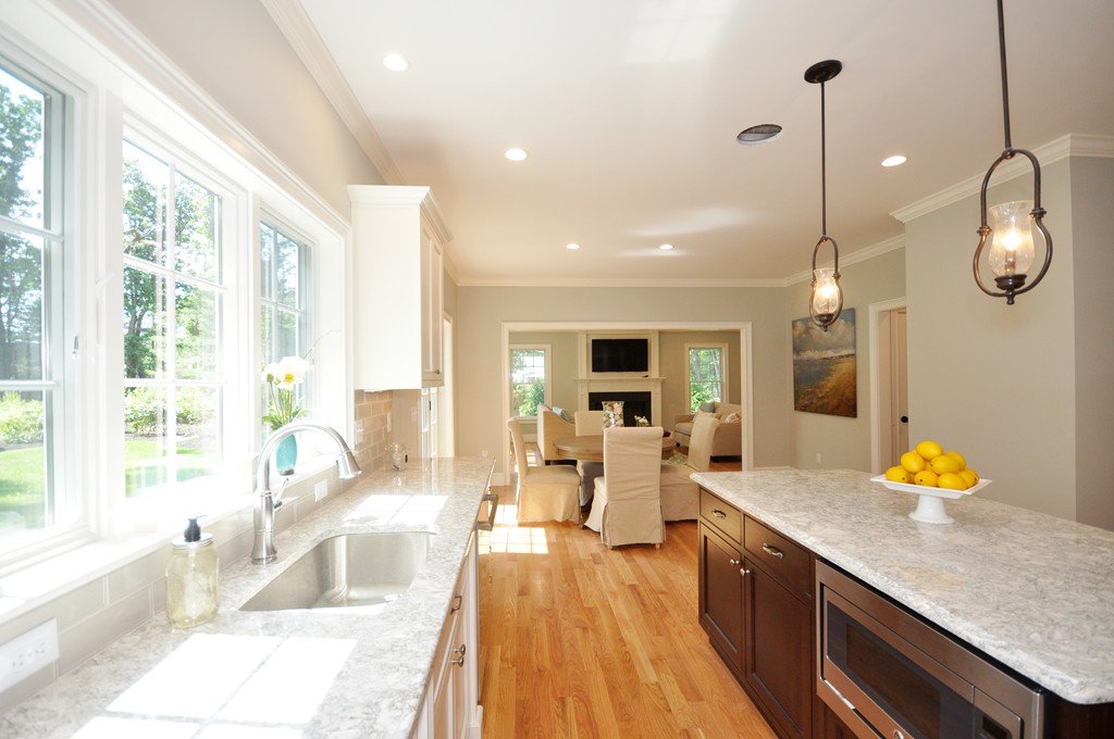 3 Irene Road Bedford, MA 01730 - Photo 14 of 26 a large kitchen with granite countertop a large window a sink and stainless steel appliances