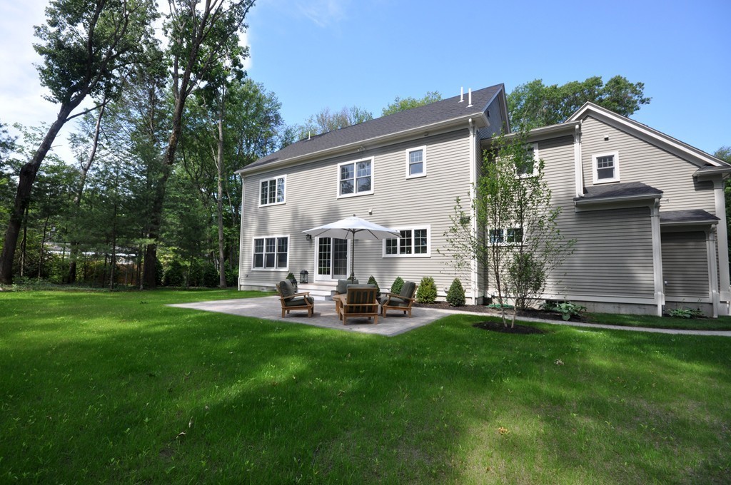 3 Irene Road Bedford, MA 01730 - Photo 4 of 26 a front view of a house with patio and garden