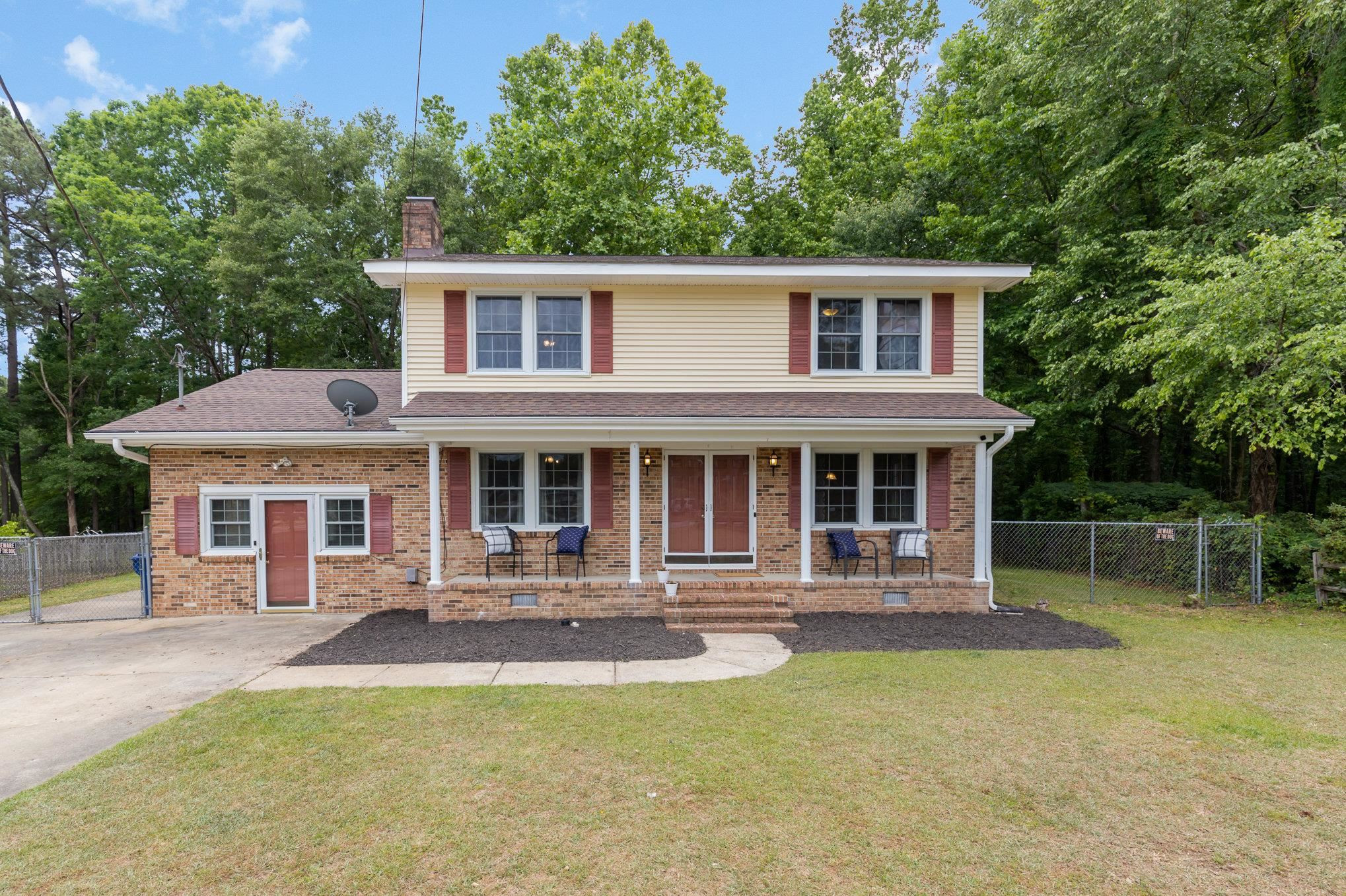 a front view of a house with a yard table and chairs