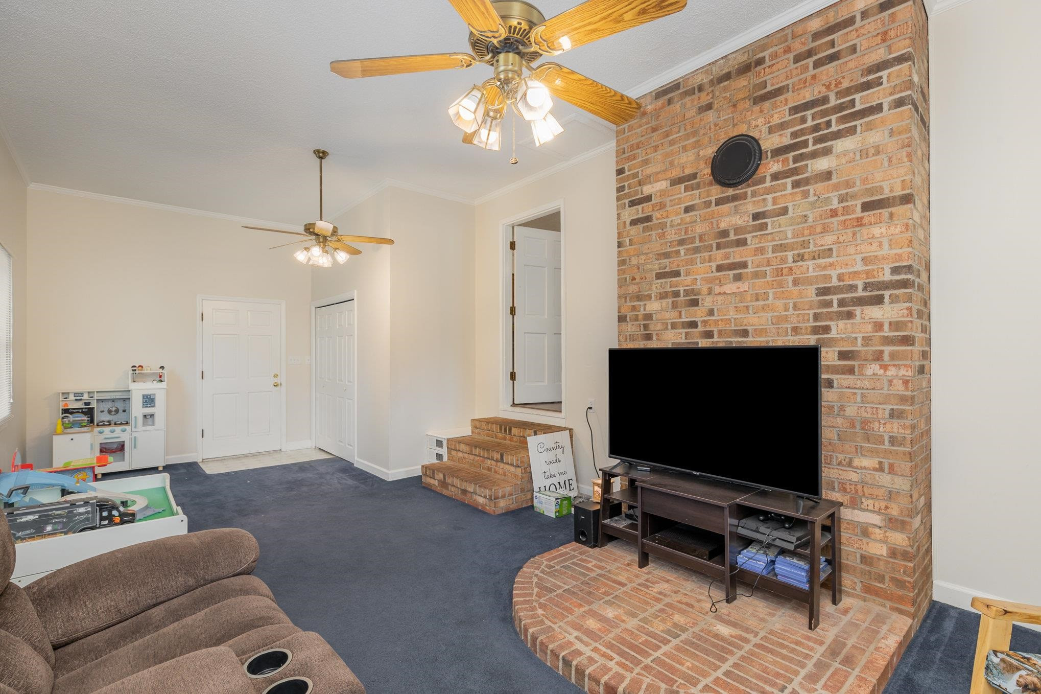 65 White Oak Drive Smithfield, NC 27577 - Photo 13 of 25 a living room with furniture and a flat screen tv