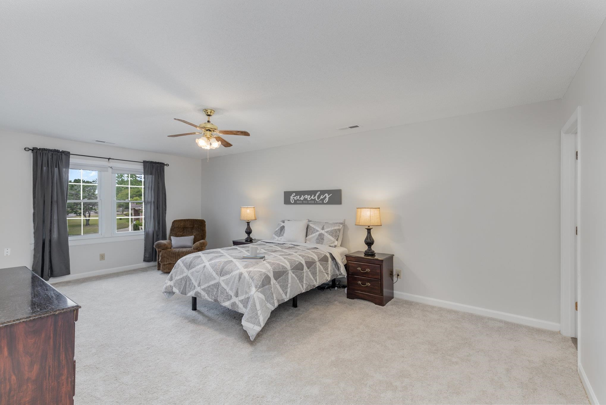 65 White Oak Drive Smithfield, NC 27577 - Photo 15 of 25 a spacious bedroom with a bed and a chandelier
