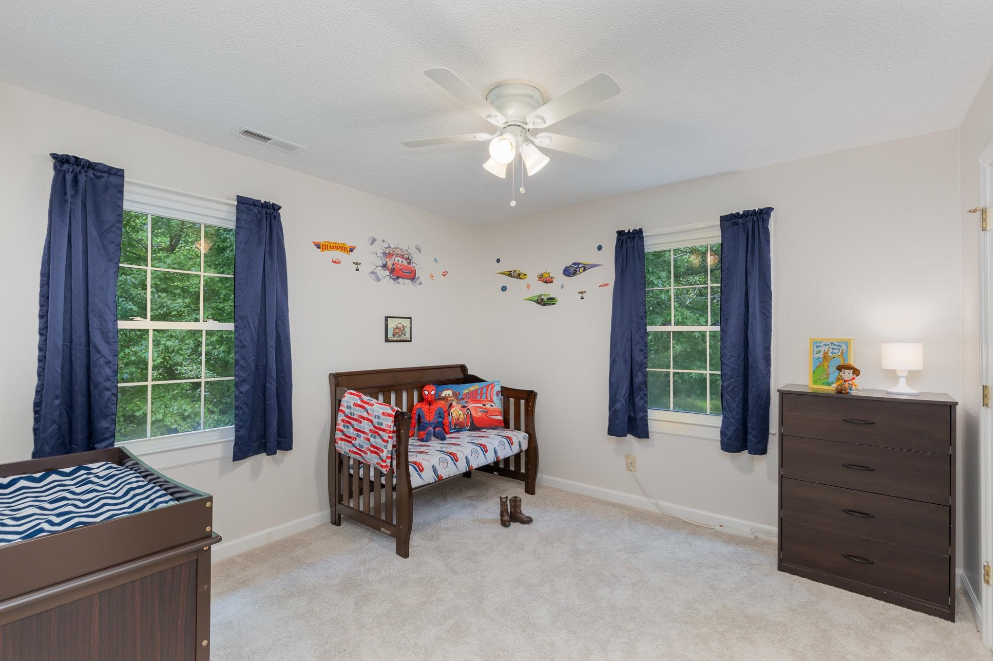 65 White Oak Drive Smithfield, NC 27577 - Photo 18 of 25 a living room with furniture a flat screen tv and a window