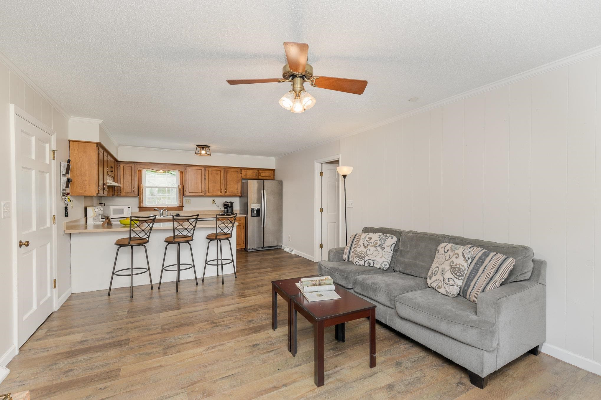 65 White Oak Drive Smithfield, NC 27577 - Photo 6 of 25 a living room with furniture kitchen view and a chandelier