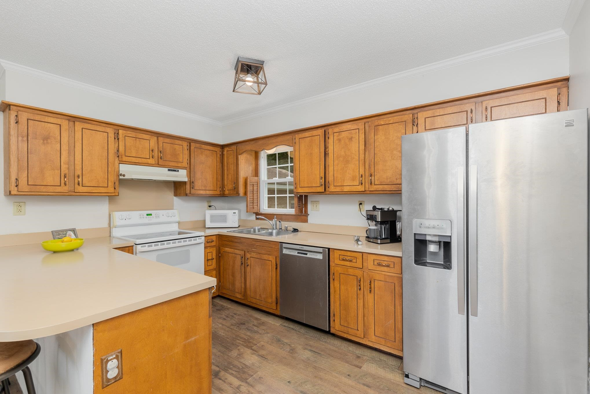 65 White Oak Drive Smithfield, NC 27577 - Photo 9 of 25 a kitchen with stainless steel appliances a refrigerator sink and cabinets