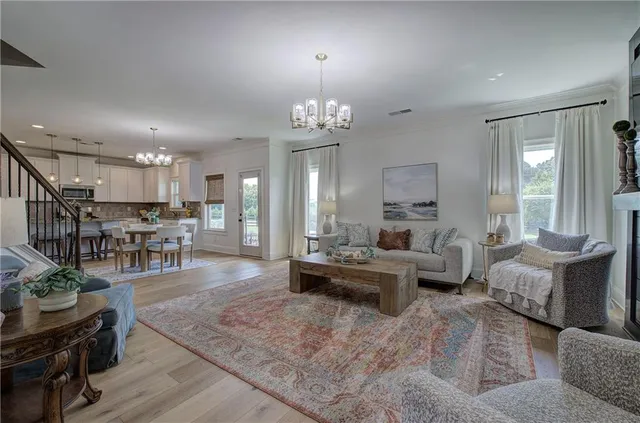 a living room with furniture and wooden floor