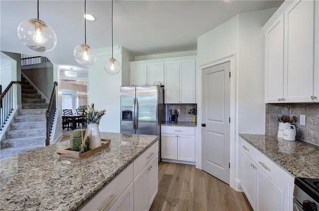 a view of a dining room with furniture a chandelier and wooden floor