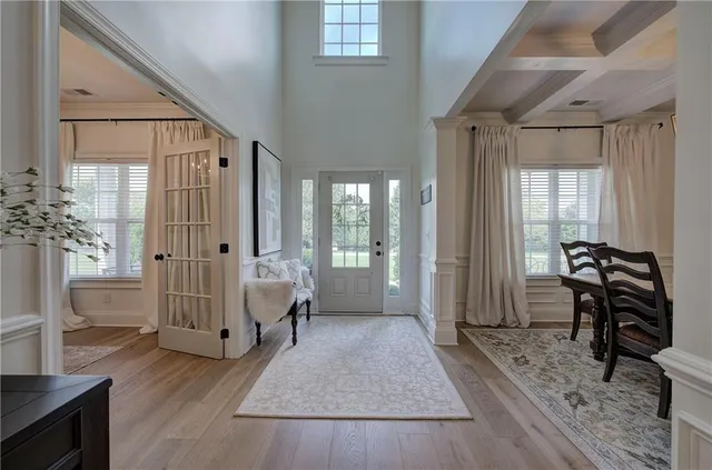 a living room with furniture and wooden floor