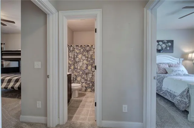 a bathroom with a granite countertop sink toilet and a mirror
