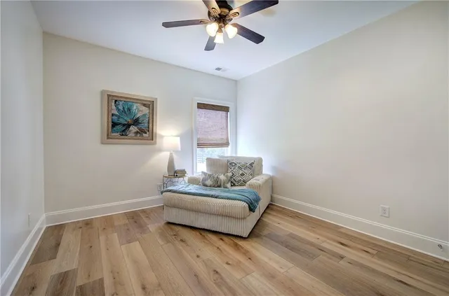 a living room with furniture and a ceiling fan