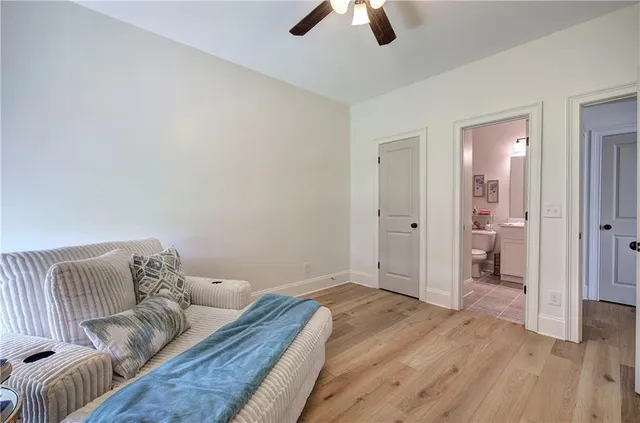 a bathroom with a granite countertop sink toilet and a mirror
