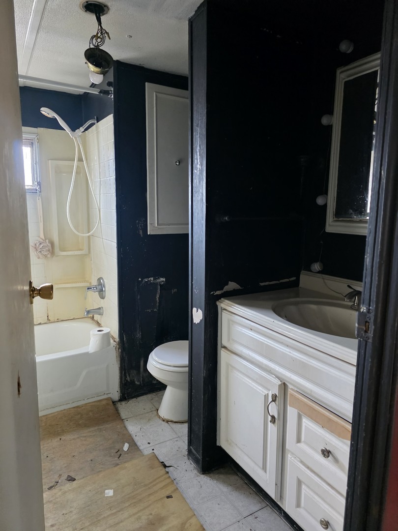 8800 South Harlem Avenue, Unit 724 Bridgeview, IL 60455 - Photo 4 of 4 a bathroom with a granite countertop sink toilet and shower