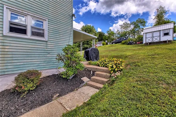 a front view of a house with garden