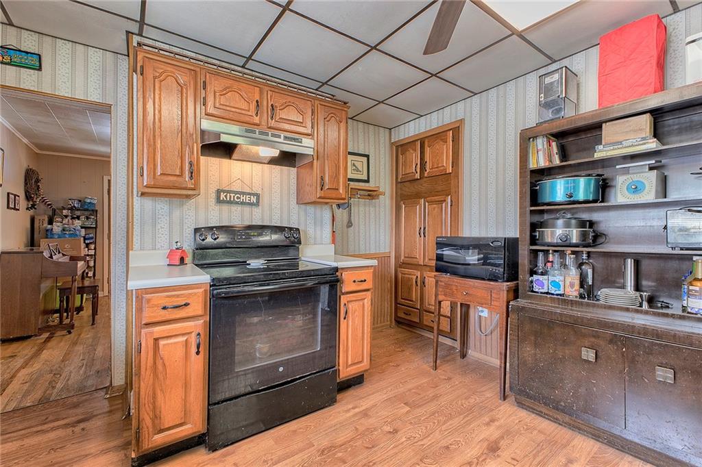 8005 Hayward Street Irwin, PA 15642 - Photo 7 of 22 a kitchen with stainless steel appliances granite countertop a stove and a wooden cabinets