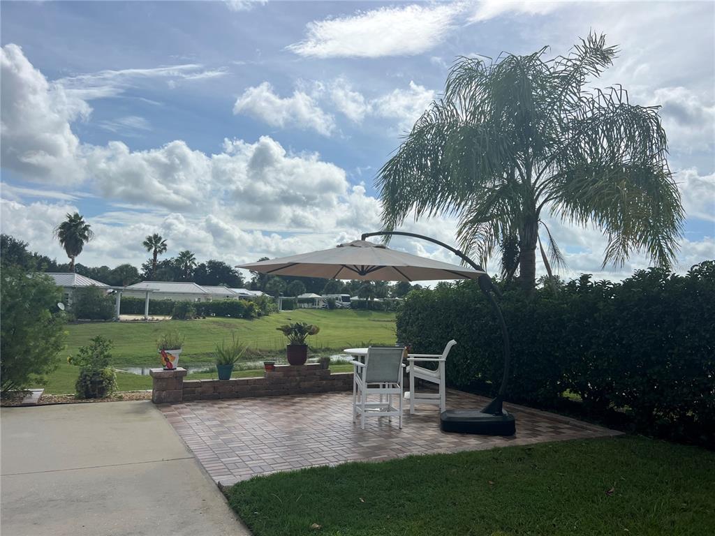9531 Southeast 47th Way, Unit 280 Webster, FL 33597 - Photo 9 of 27 a view of a garden with patio