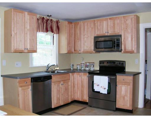 46 Gleason Road Lexington, MA 02420 - Photo 2 of 5 a kitchen with granite countertop a sink dishwasher stove and microwave with wooden cabinets