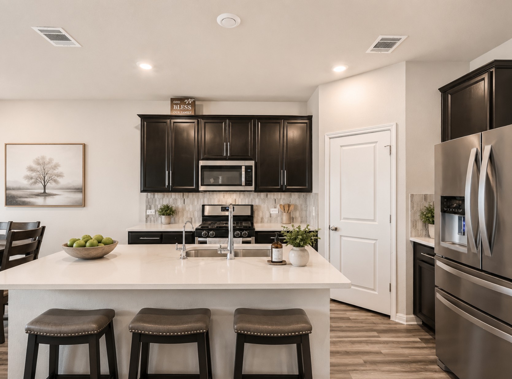 1416 Deering Run Leander, TX 78641 - Photo 8 of 21 a kitchen with stainless steel appliances a sink a stove a refrigerator cabinets and chairs