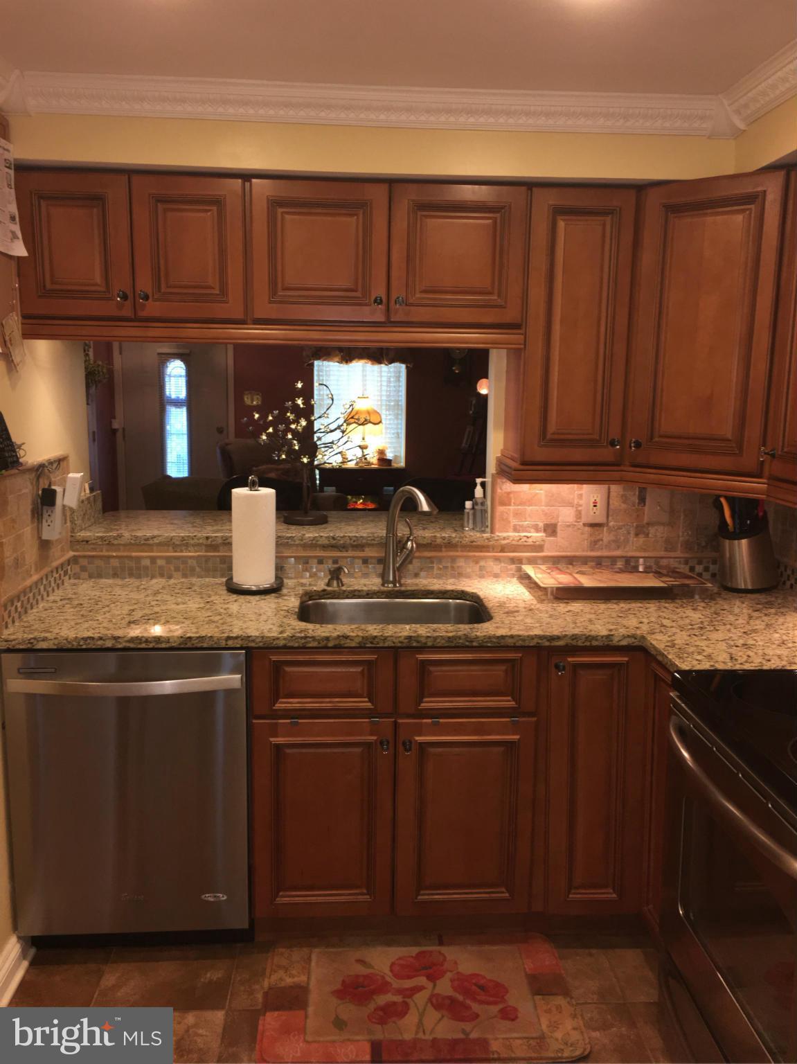 2232 Riding Crop Way Baltimore, MD 21244 - Photo 7 of 12 a kitchen with granite countertop wood cabinets and a sink