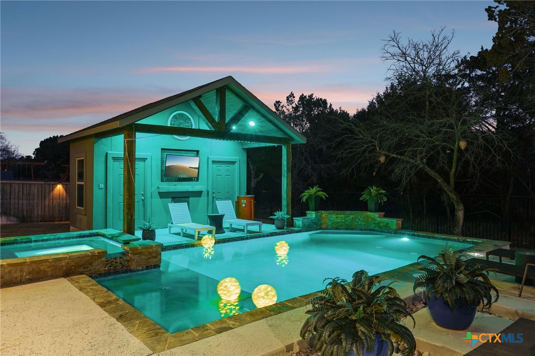 424 Heidelberg Road New Braunfels, TX 78132 - Photo 34 of 41 a view of a house with backyard outdoor seating and a garden