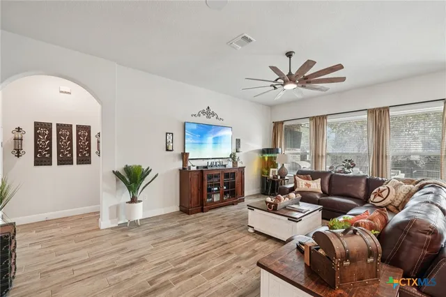 a kitchen with stainless steel appliances granite countertop a sink a stove and a wooden cabinets